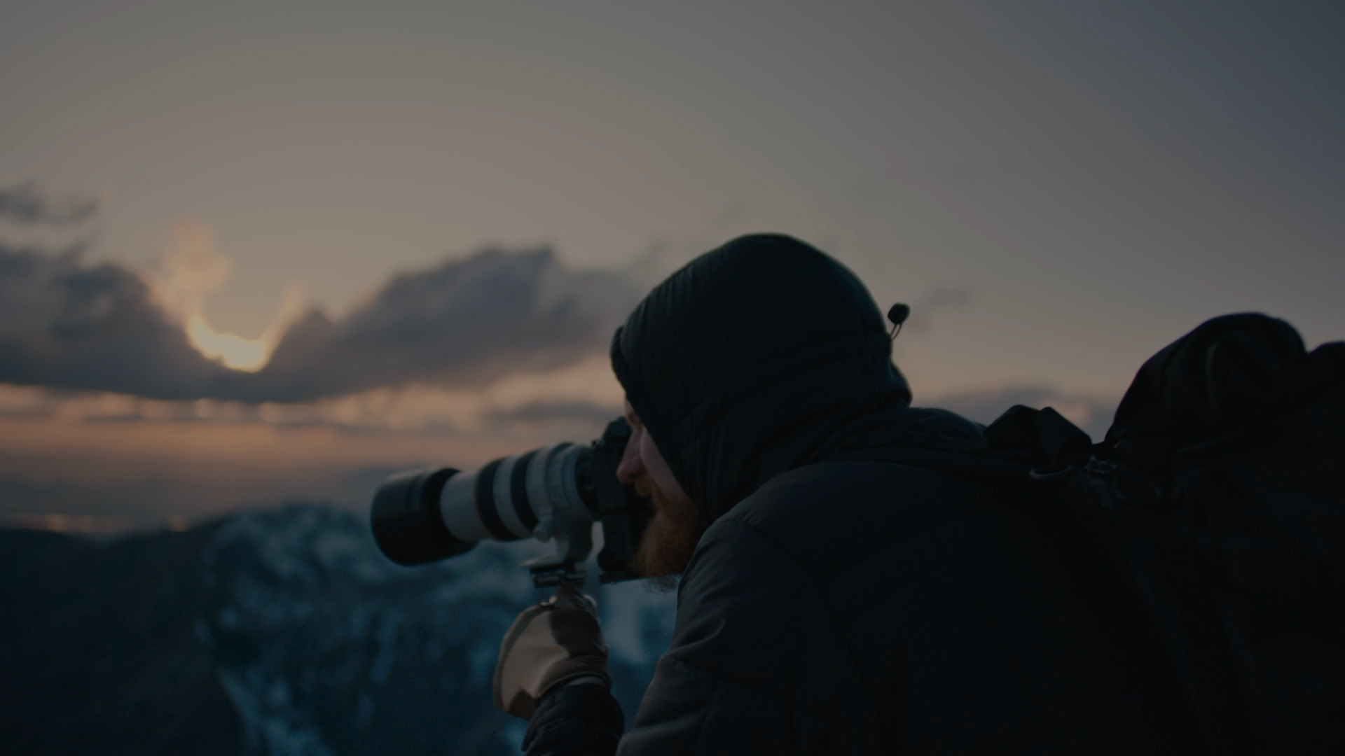 Photographer at dusk in the mountains