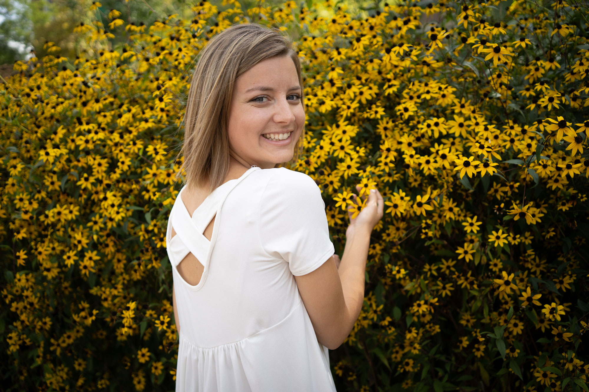 Lady in front of flowers