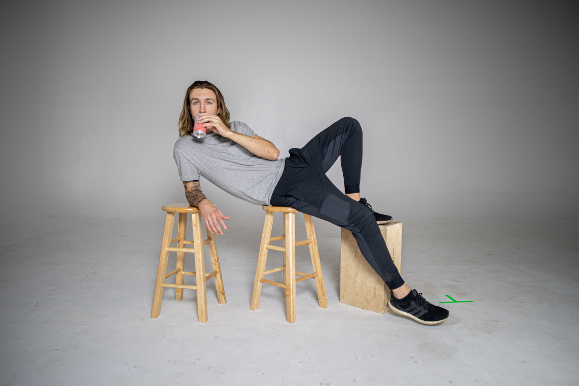 Man posing on stools