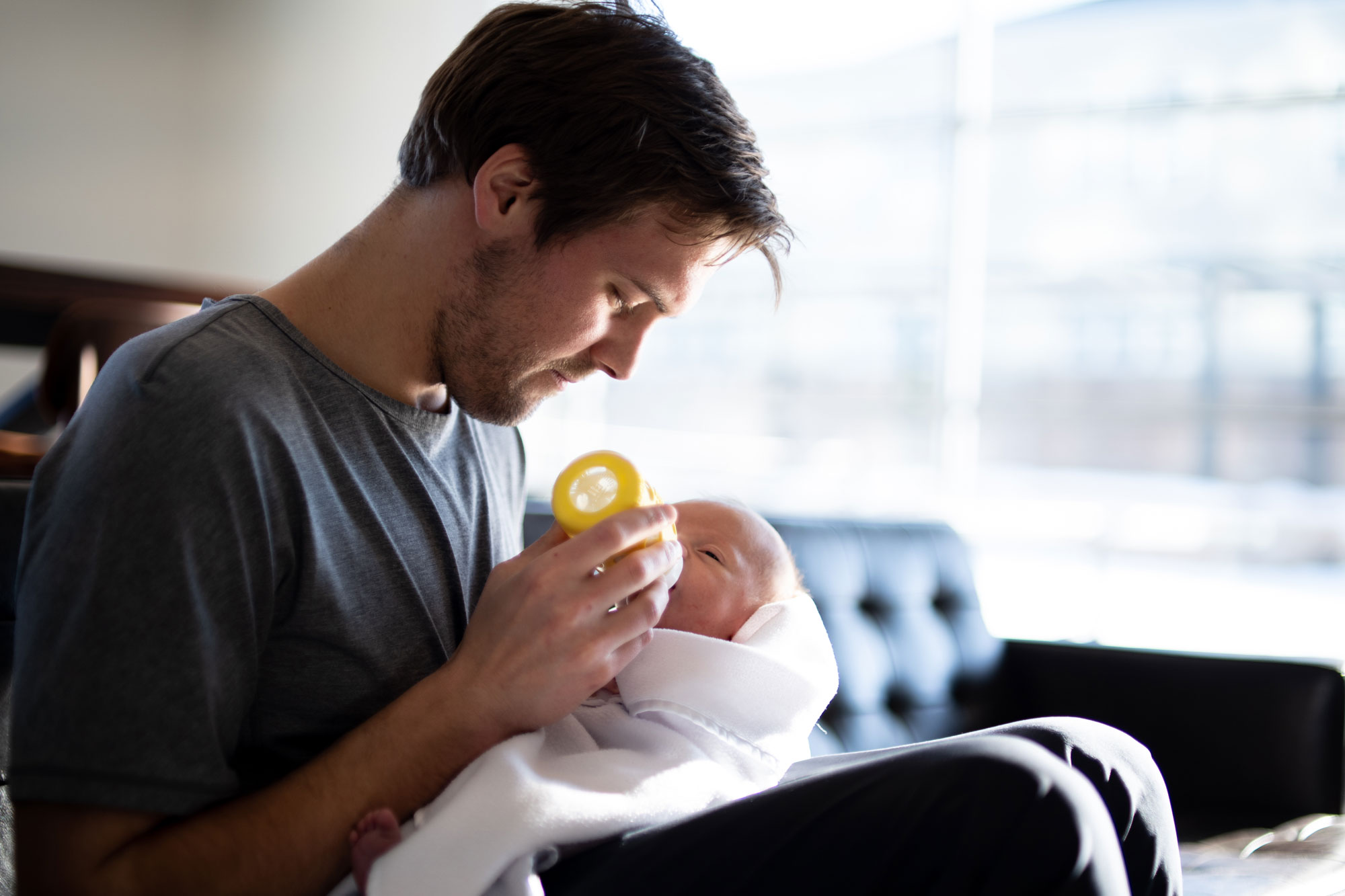 Father feeding baby with bottle